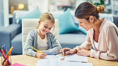 A mother helping her daughter with homework.
