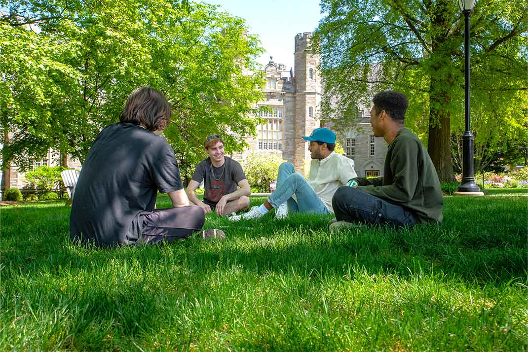 4 wcu students sitting on the quad together