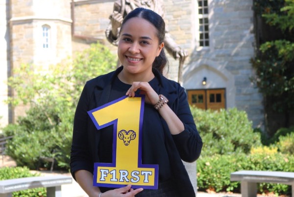 Student holding 1 sign in west chester colors